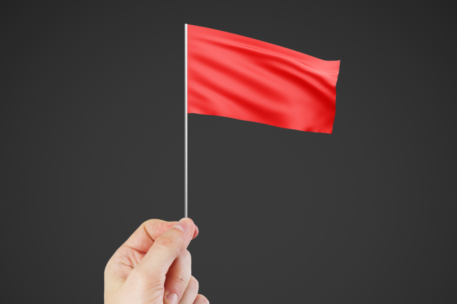 A hand waving a single red flag.