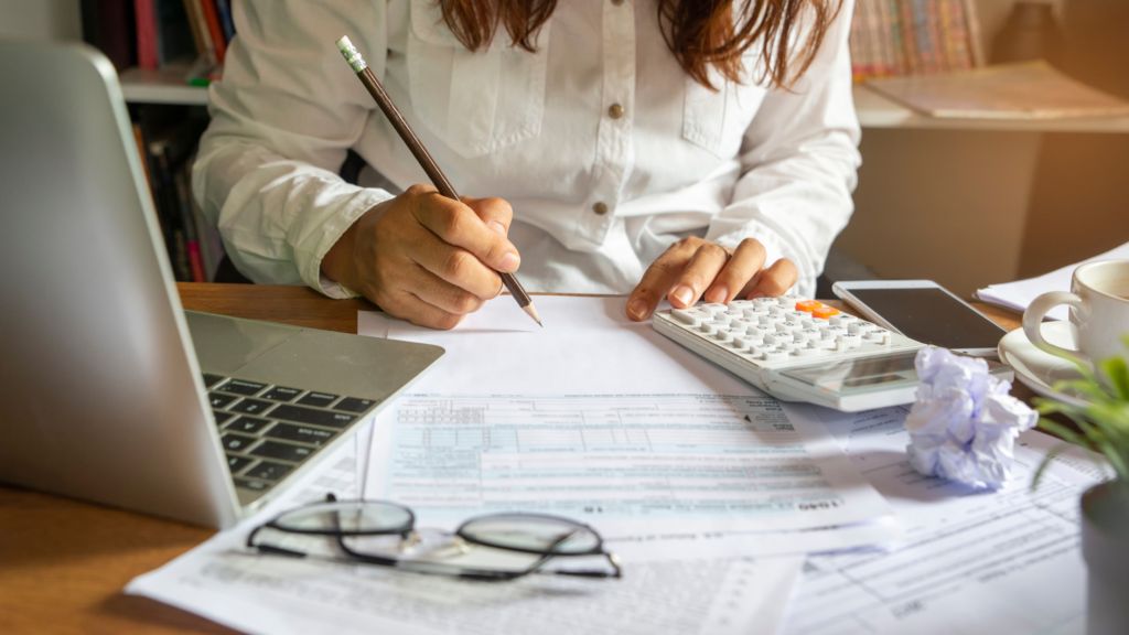A woman at a desk planning and organizing at the office.