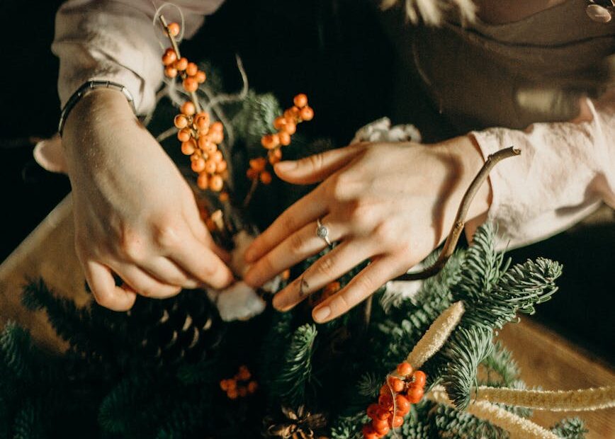 person fixing green christmas tree