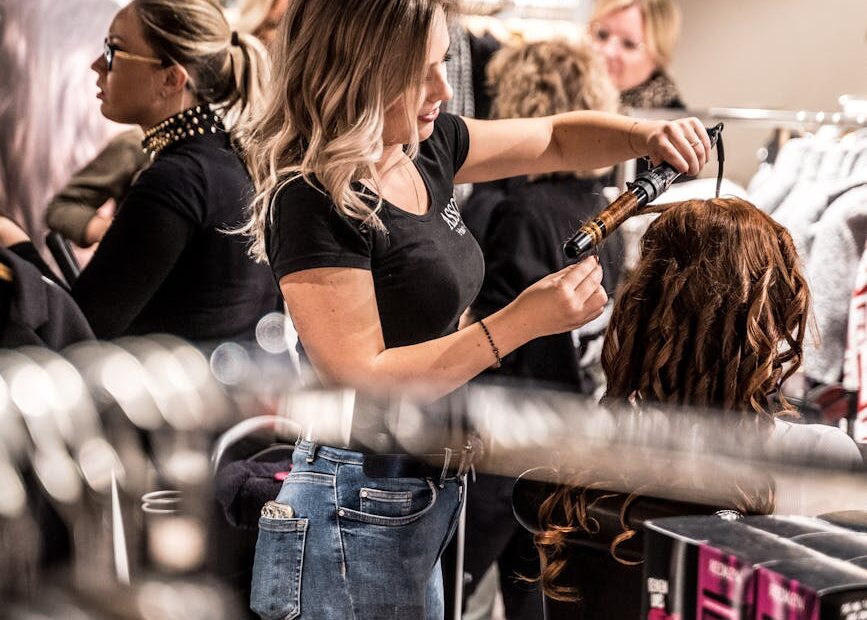 woman curling another woman s hair
