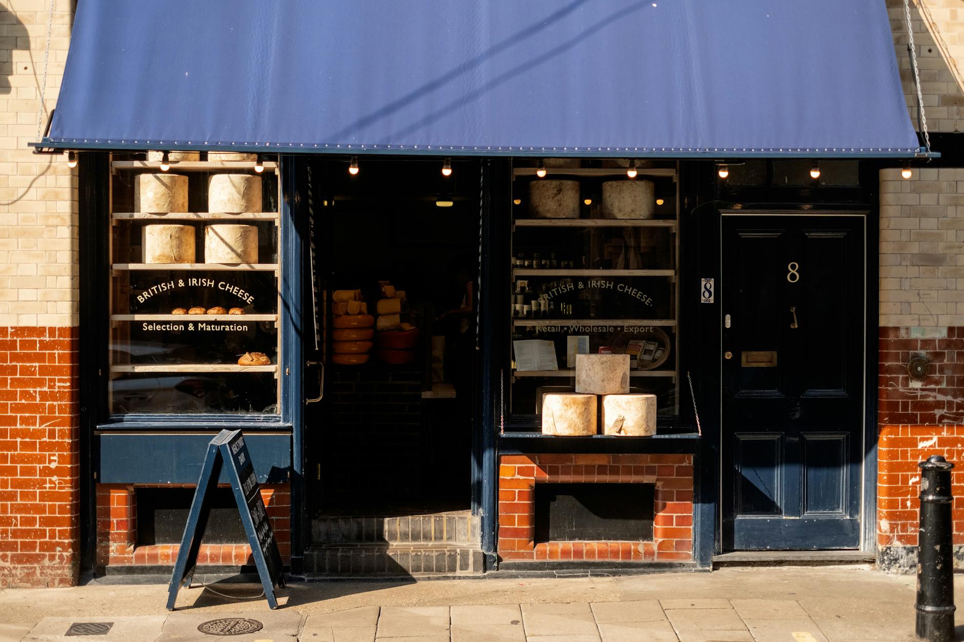charming cheese shopfront with blue awning